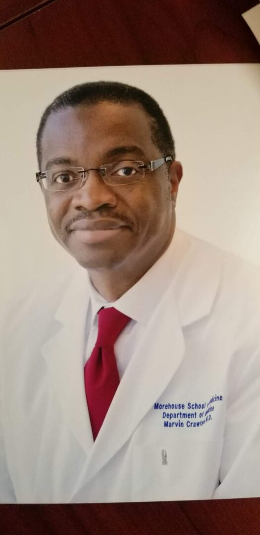 A man in white coat and red tie.