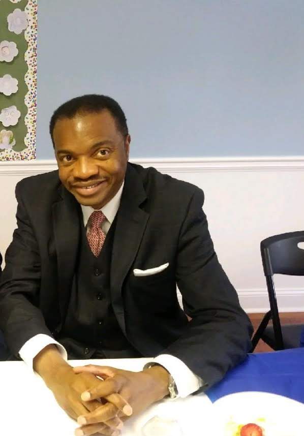 A man in a suit sitting at a table