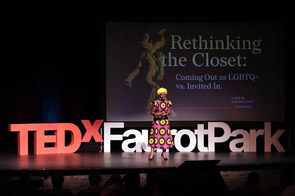 A person standing on stage with an audience