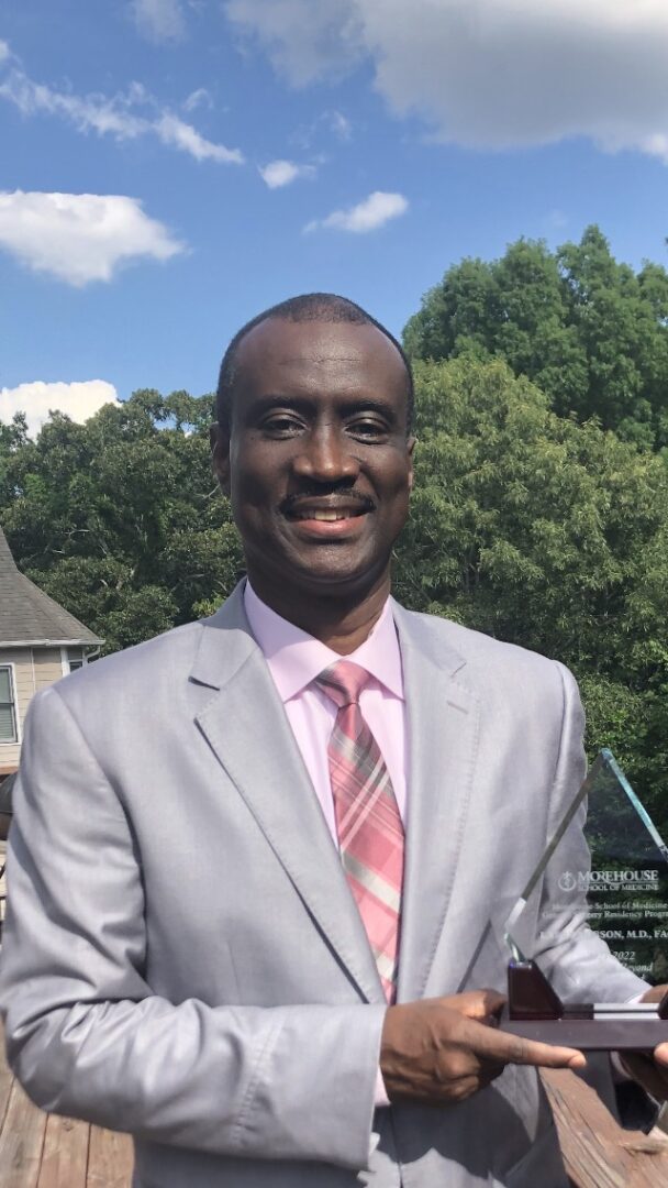 A man in a suit and tie standing outside.
