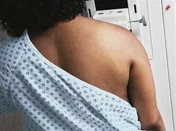A woman with her back turned to the camera.