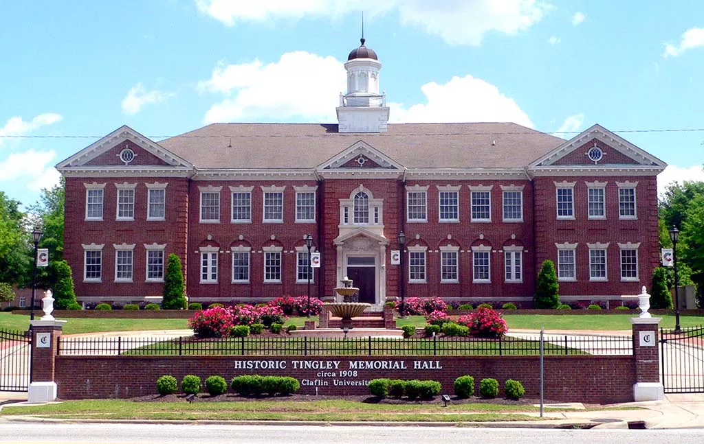 A large building with flowers in front of it.