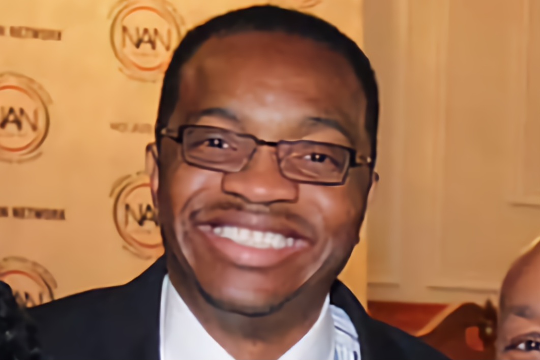 A man with glasses smiling for the camera.