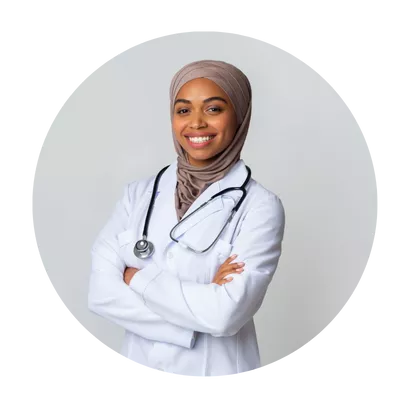 A woman in white coat with head scarf and stethoscope.