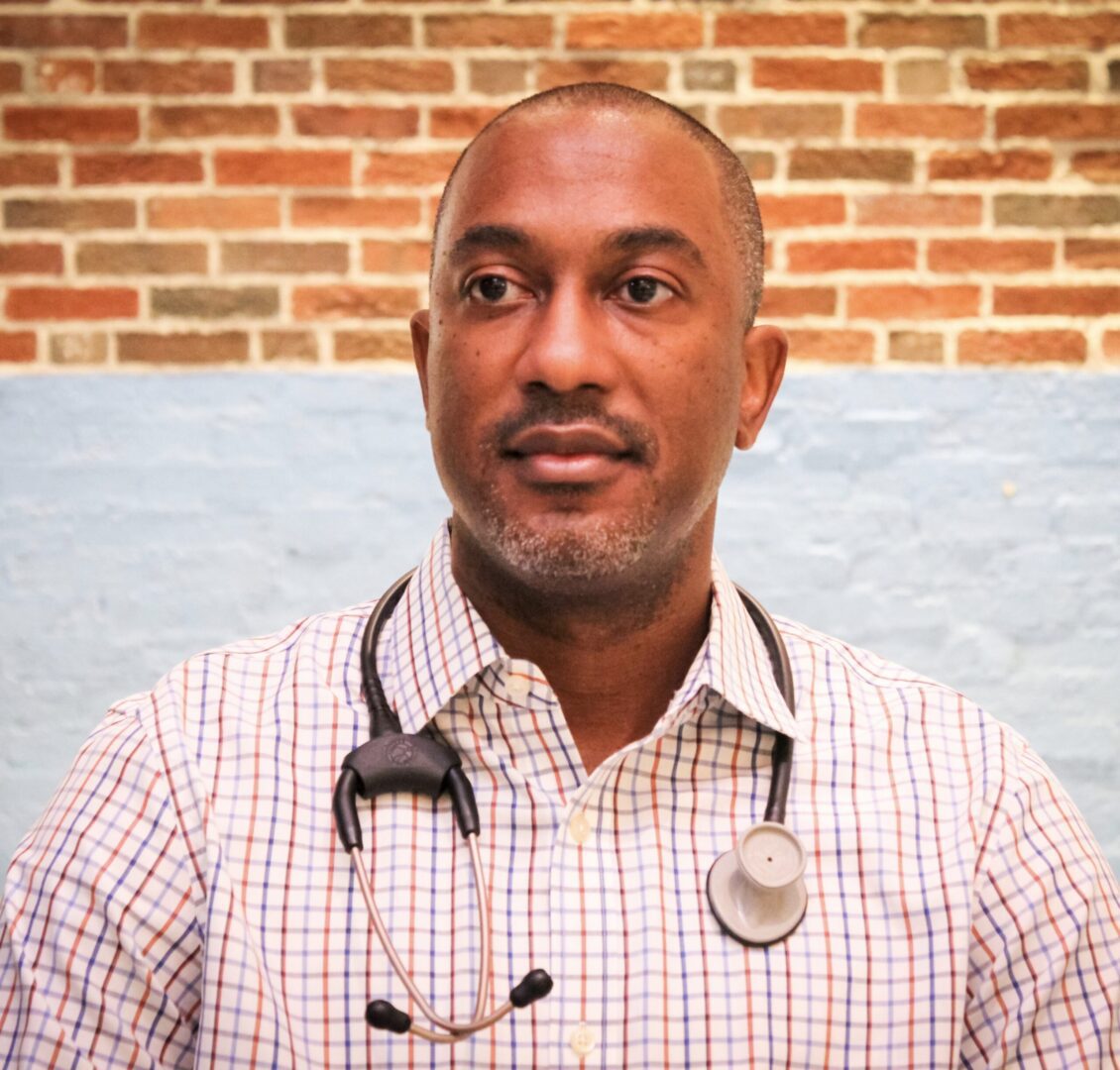 A man with a stethoscope around his neck.