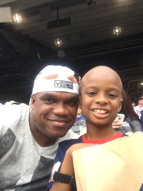 A man and boy are smiling for the camera.