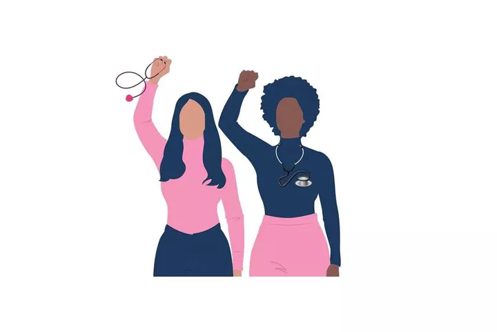Two women standing next to each other holding up their hands.