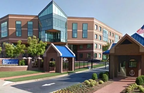 A building with a blue roof and a walkway.