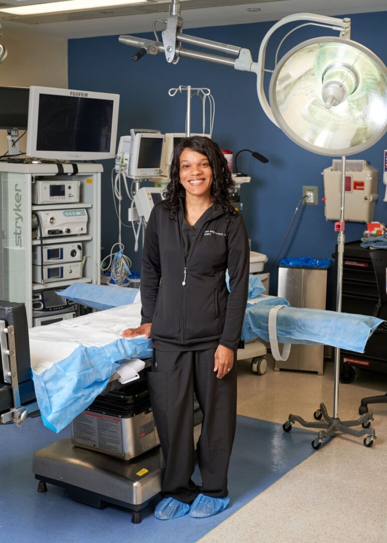A woman standing in front of an operating room.