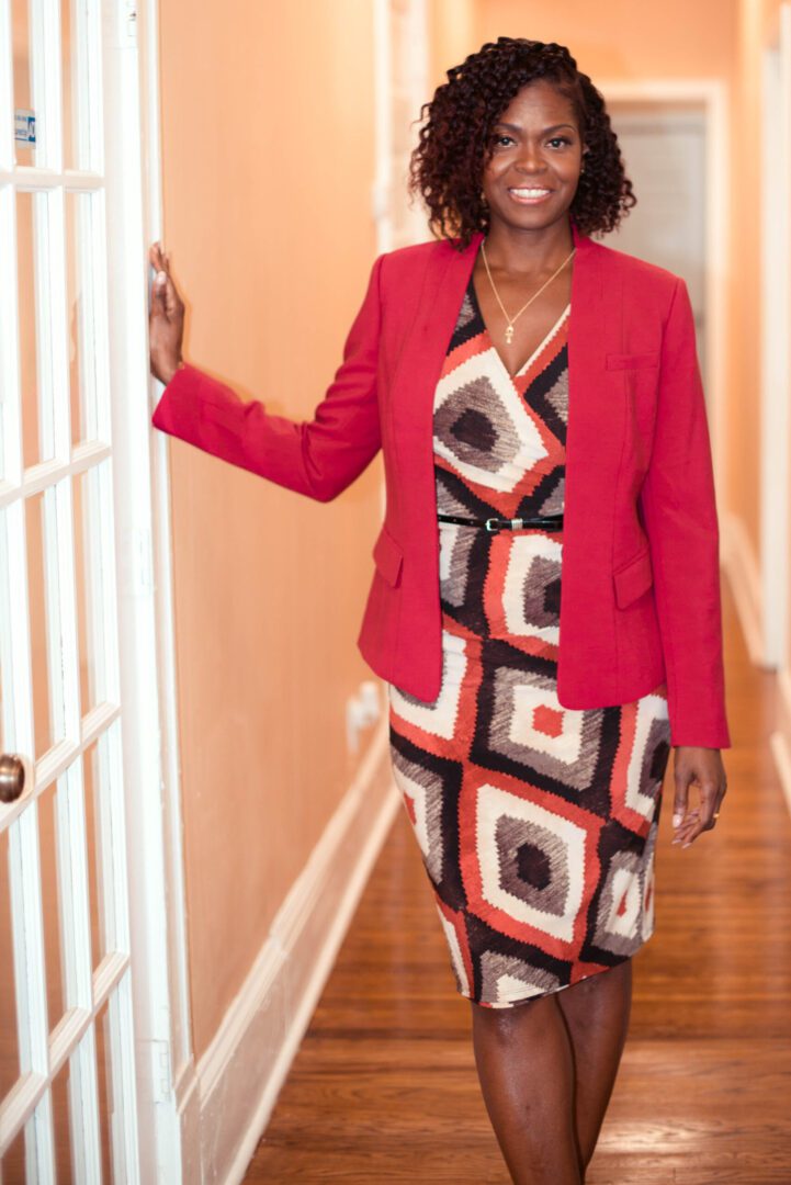 A woman in a red jacket and dress