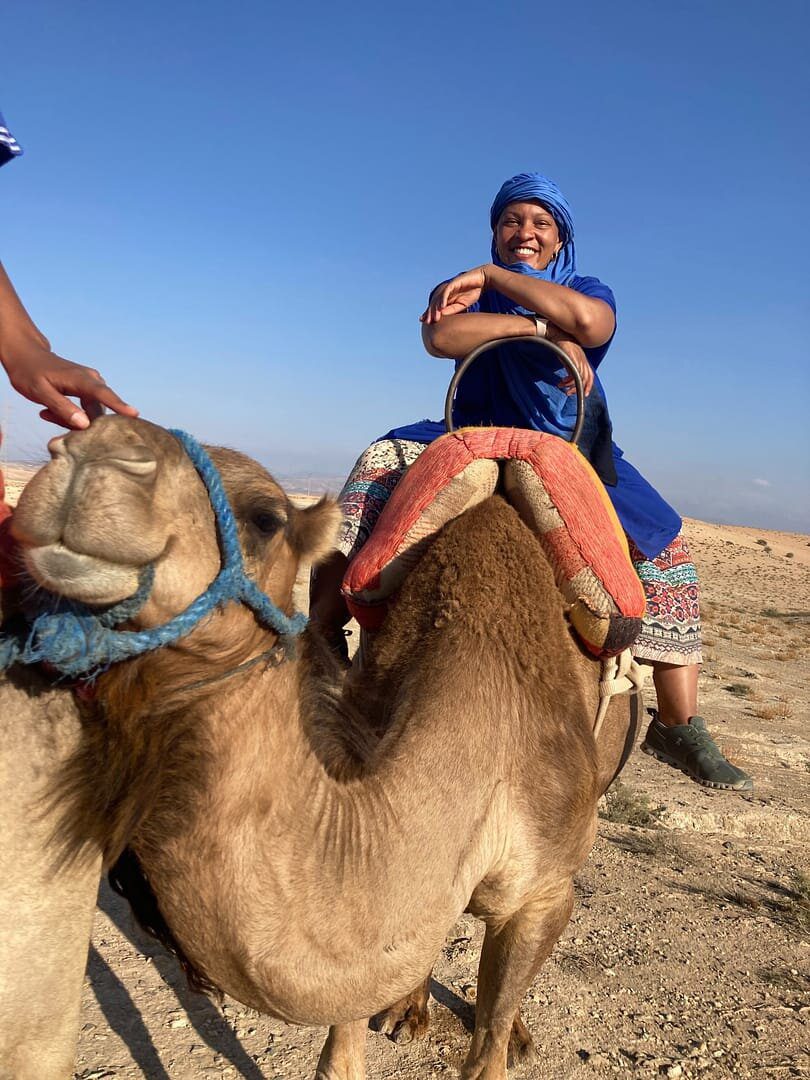 A man riding on the back of a camel.