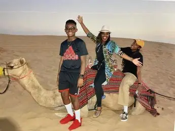 A group of people riding on the back of a camel.