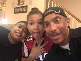 A man and two boys posing for the camera.