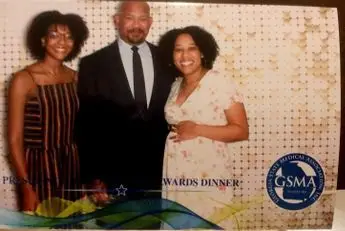 A picture of two women and one man.