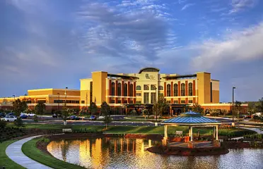 A large building with a pond in front of it.