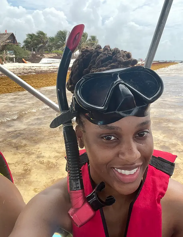 Woman wearing a snorkel and life vest.