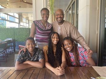 A family posing for a picture on the table