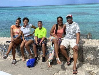 A group of people sitting on the beach