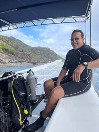 A man sitting on the back of a boat.