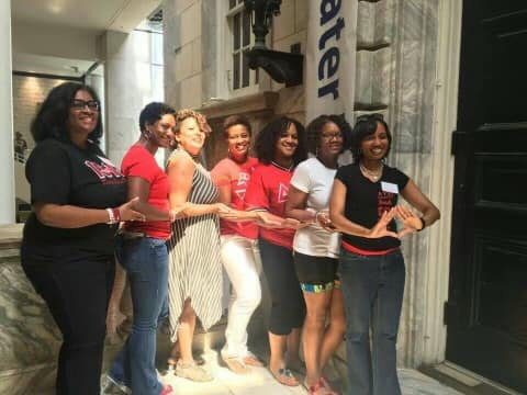 A group of women standing in front of a building.