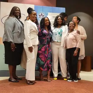 A group of women standing next to each other.