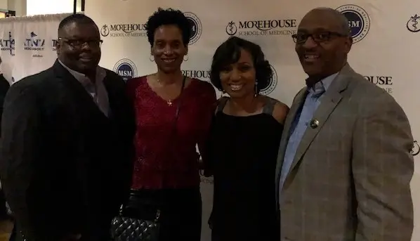 Four people smiling at Morehouse School of Medicine event.