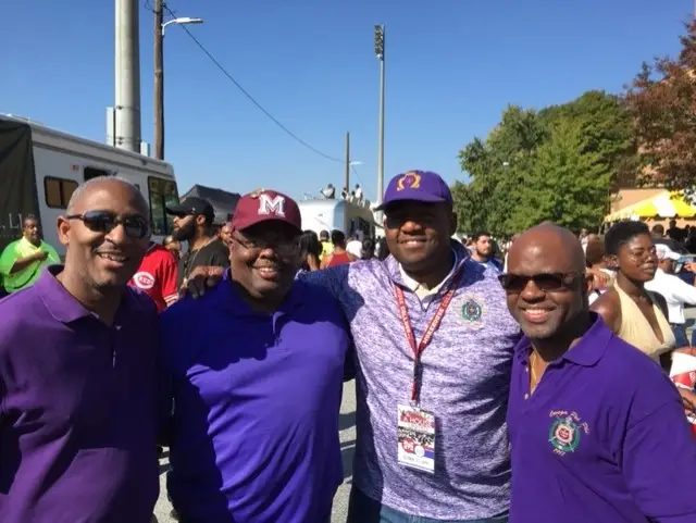 A group of men standing next to each other.