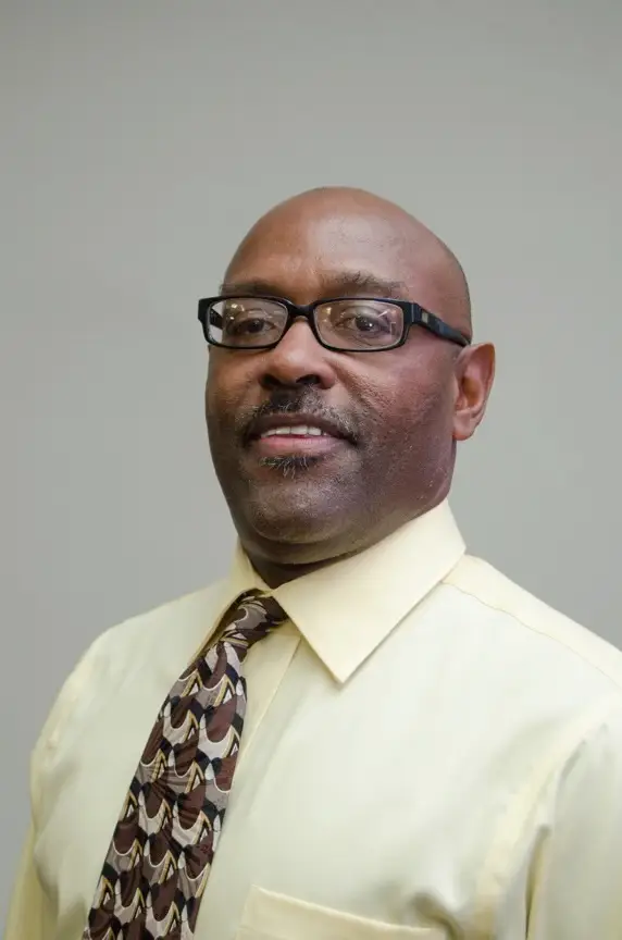 A man in glasses and a tie.