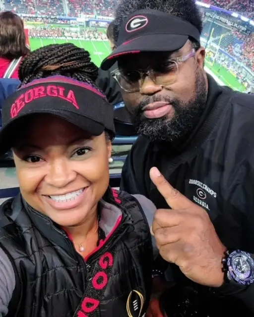 A woman and man are smiling for the camera.