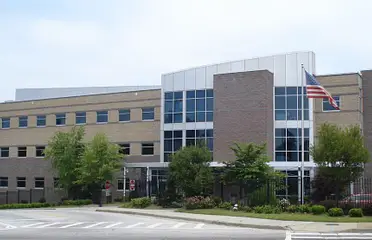 A large building with trees in front of it