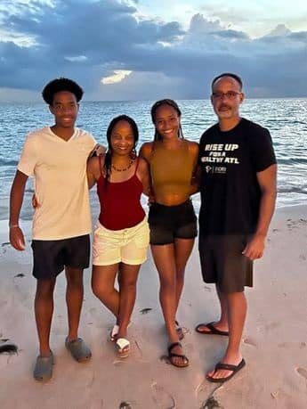 A group of people standing on top of a beach.