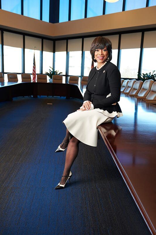 A woman sitting on top of a wooden table.