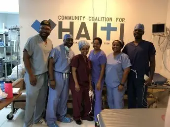 A group of doctors standing in front of a wall.