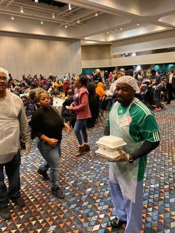 A group of people standing around in an event.