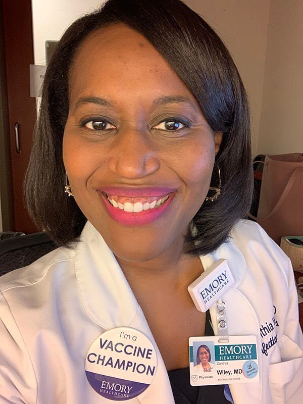 A woman with a badge around her neck.