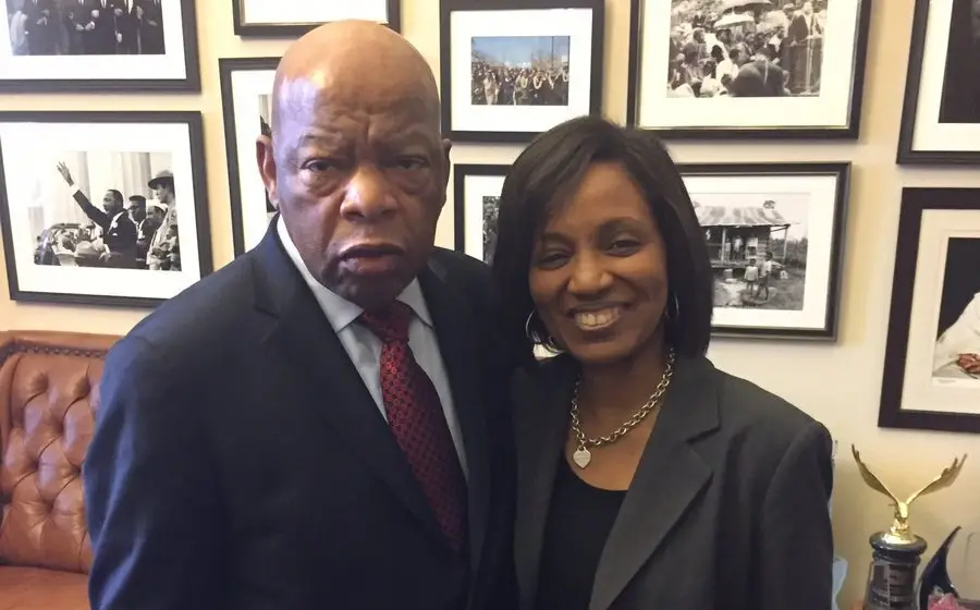 John Lewis and a woman in suits.