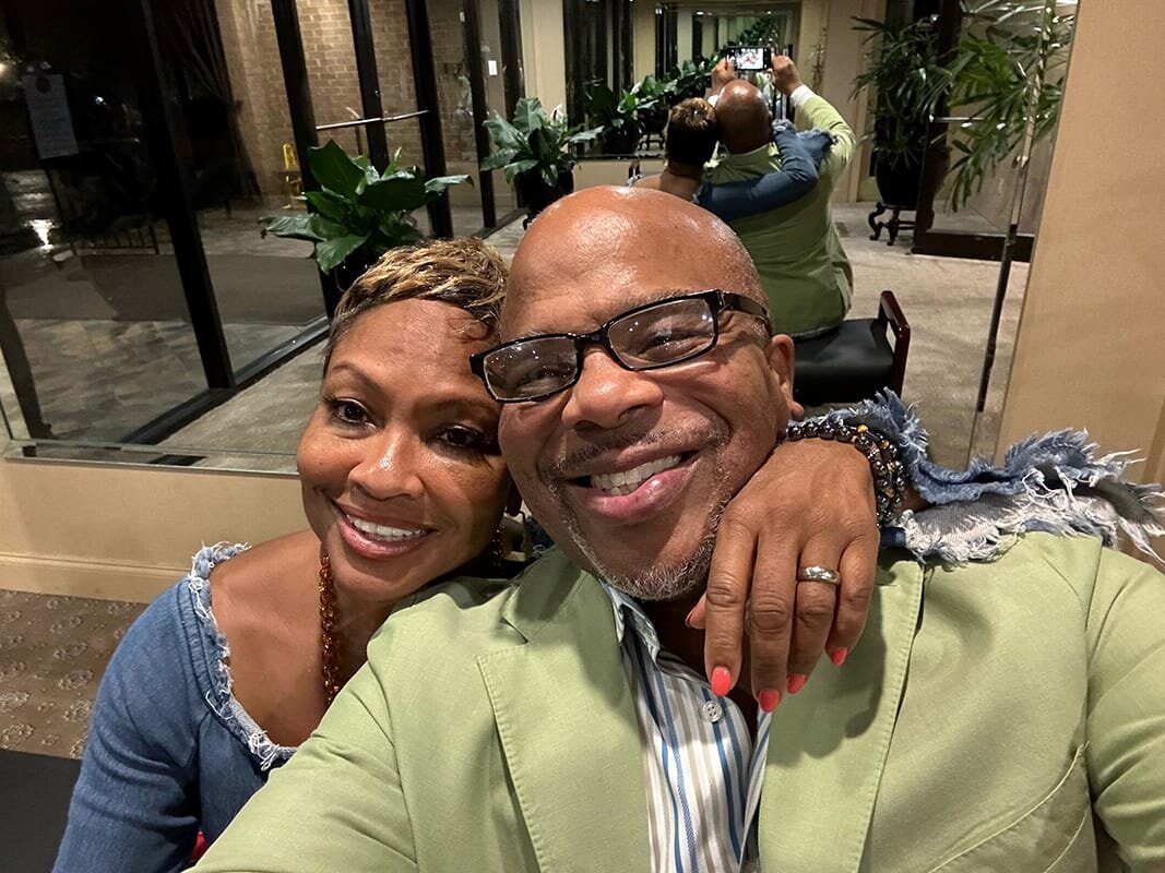 A man and woman are smiling for the camera.