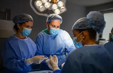 A group of surgeons in the operating room.