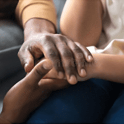 A close up of two people holding hands